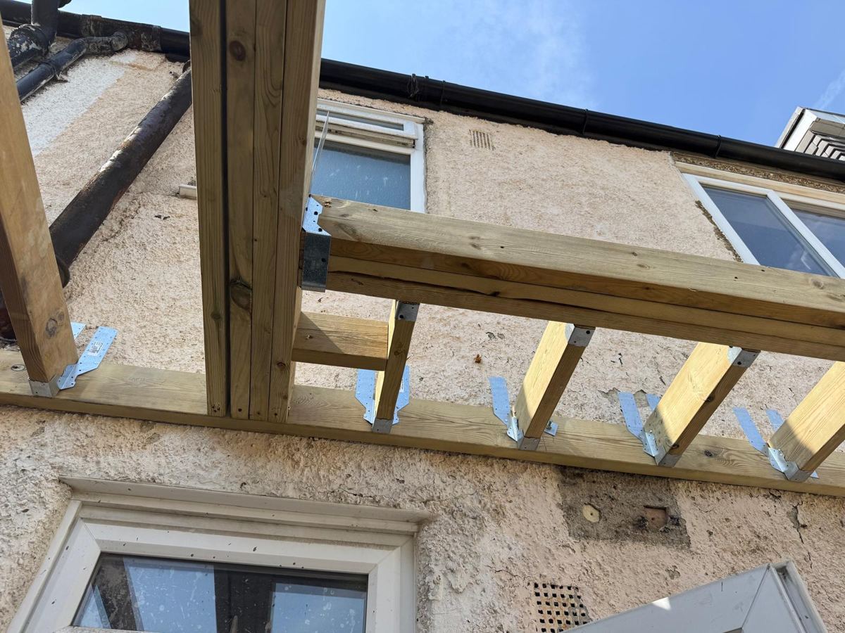 New joists fixed on hangers to the wall plate