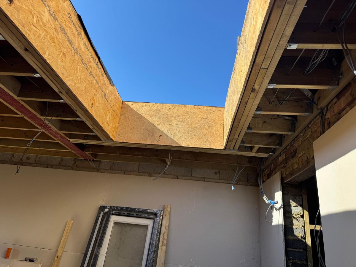 Steel beam in with new roof joists over the shell