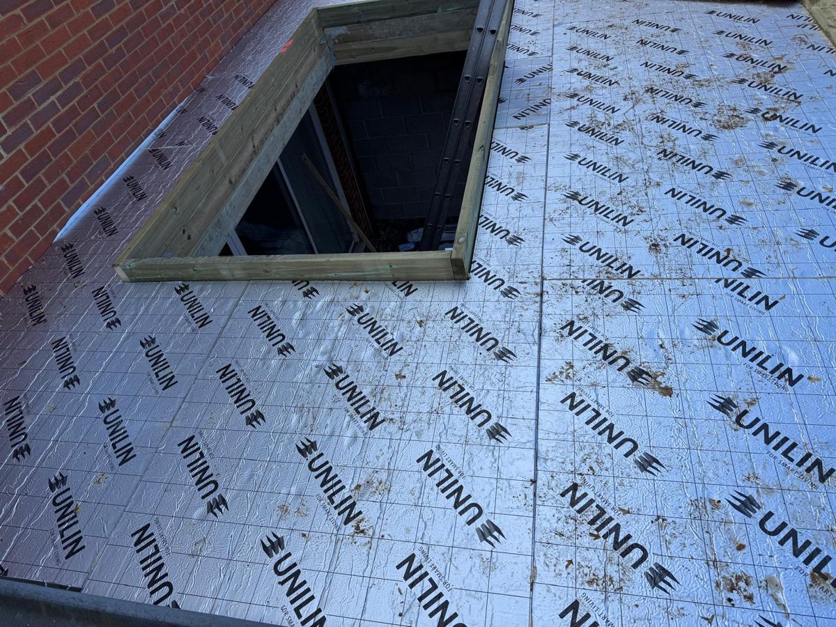 Insulation boards fitted around the rooflight upstand